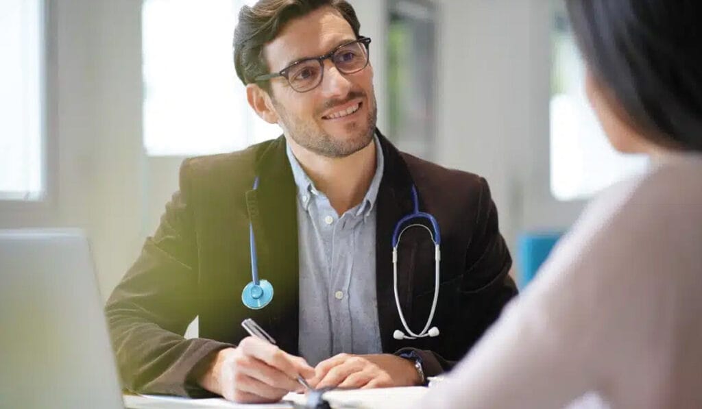 Private GP giving a consultation