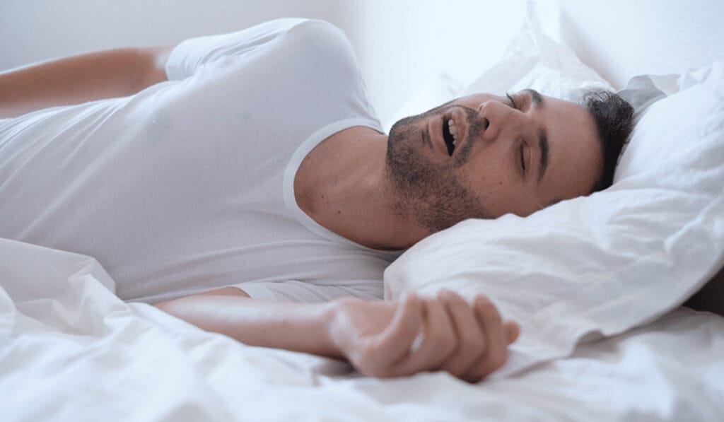 Sleeping man with sleep apnoea